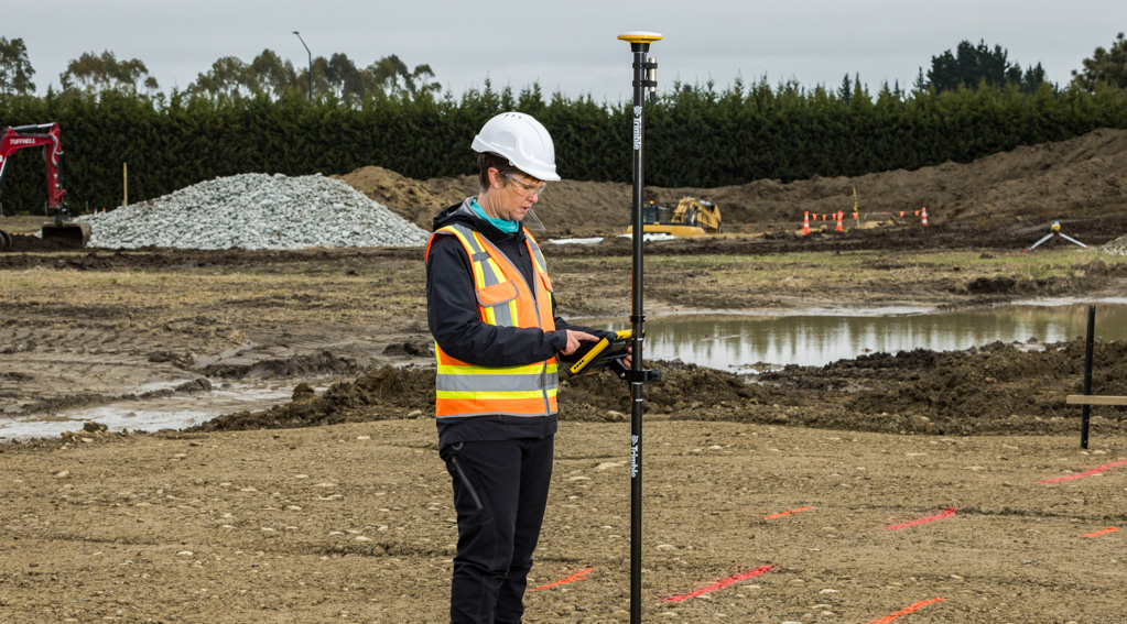 Woman in the field using trimble catalyst 